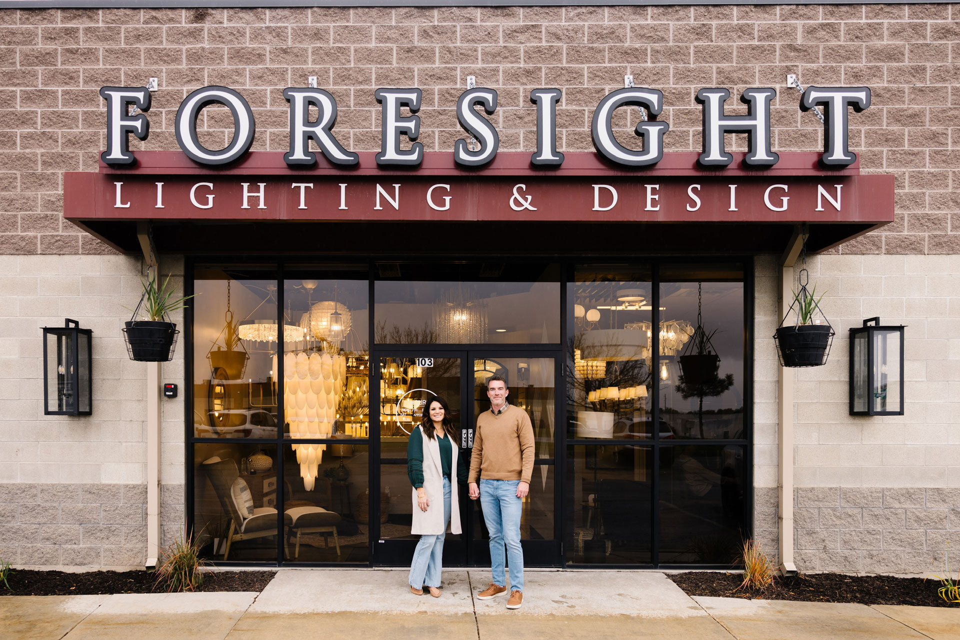 Man and woman in front of Foresight lighting & design store